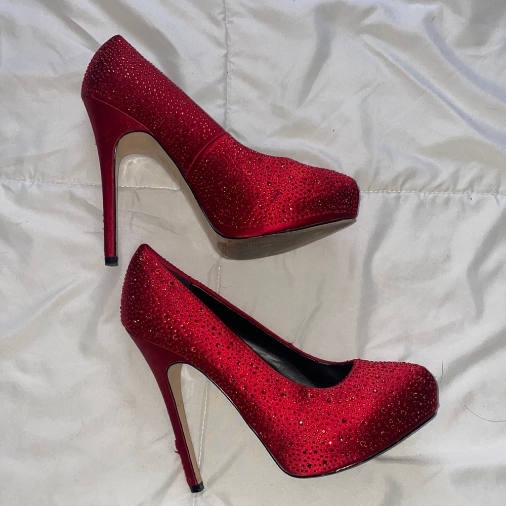 Red rhinestone heels size 8.5 used has some rips on lower heels from Aldo